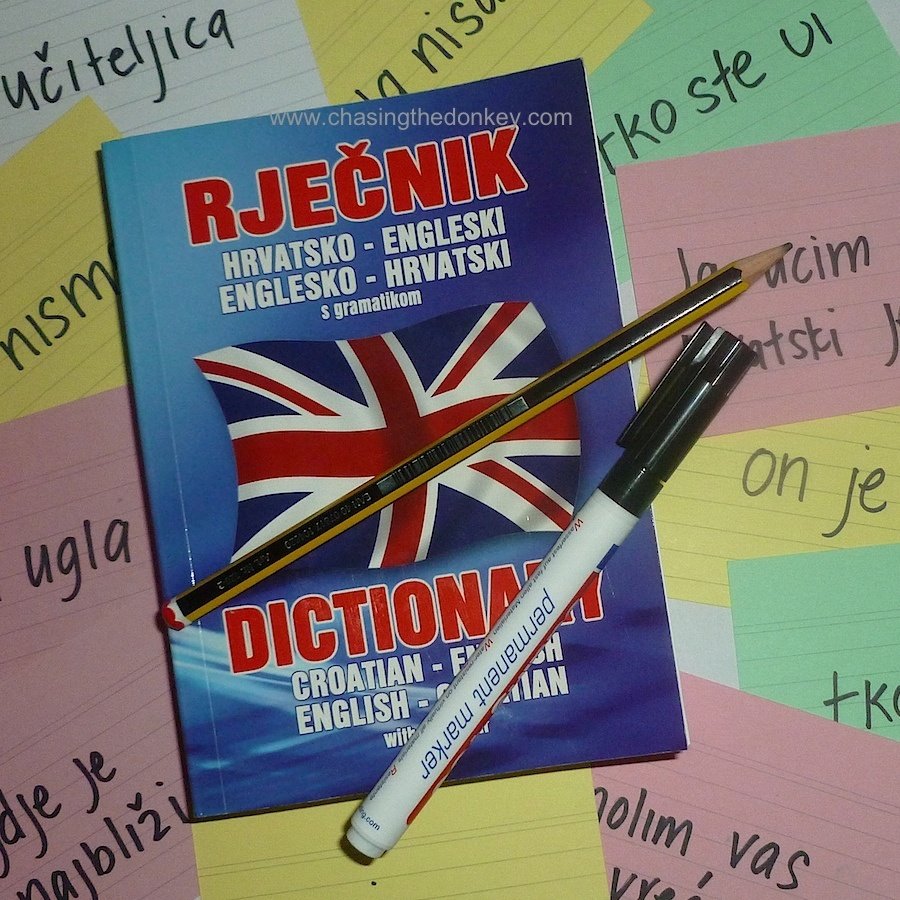 A book with the words ABC's and a pen for learning the English language.