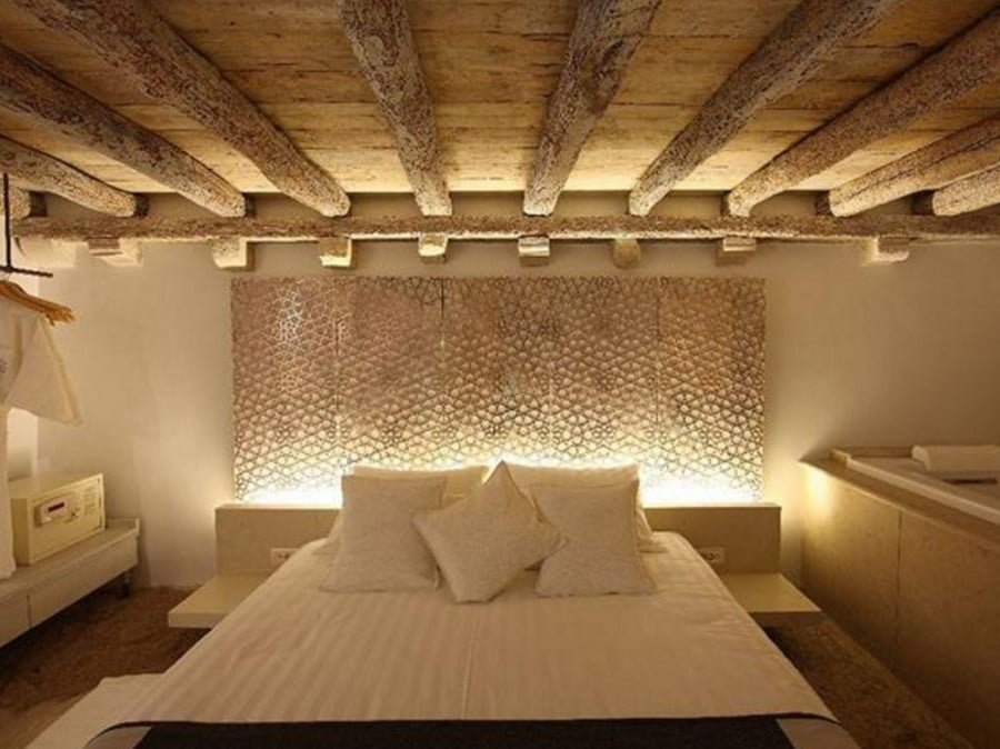 A bedroom in Korcula with wooden beams and a bed.