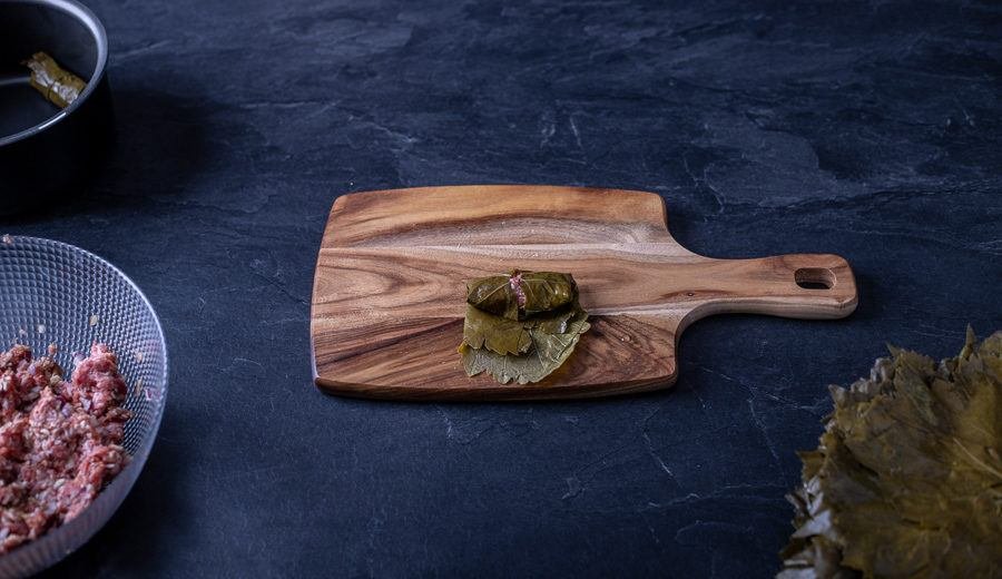 A wooden cutting board with food on it.
