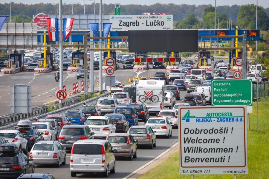 A large group of cars explore Croatia on a highway.