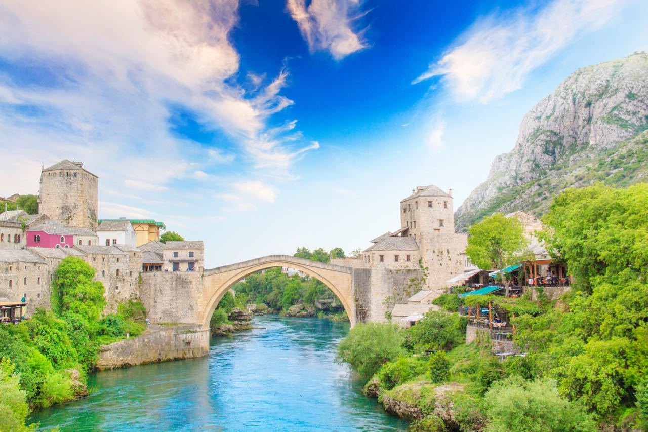 An old bridge over a river in Mostar Bosnia and Herzegovina, perfect for backpackers exploring the Balkans.