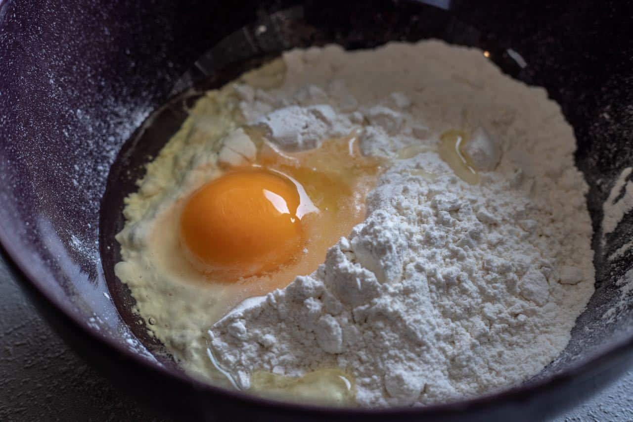 Slavonski Fiš Paprikaš: An egg and flour in a bowl.
