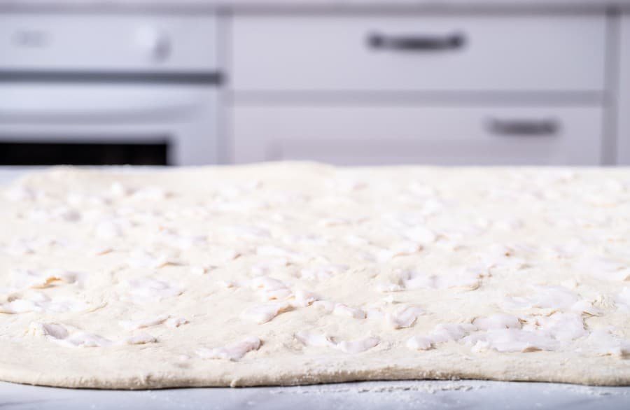 A Croatian salenjaci dough on a counter in a kitchen.