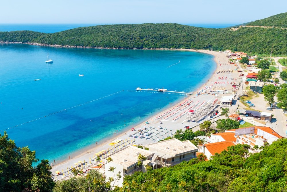 Best Beaches In The Mediterranean - View from above on Adriatic sea coastline and Jaz beach at Montenegro, nature landscape, vacations to the summer paradise.