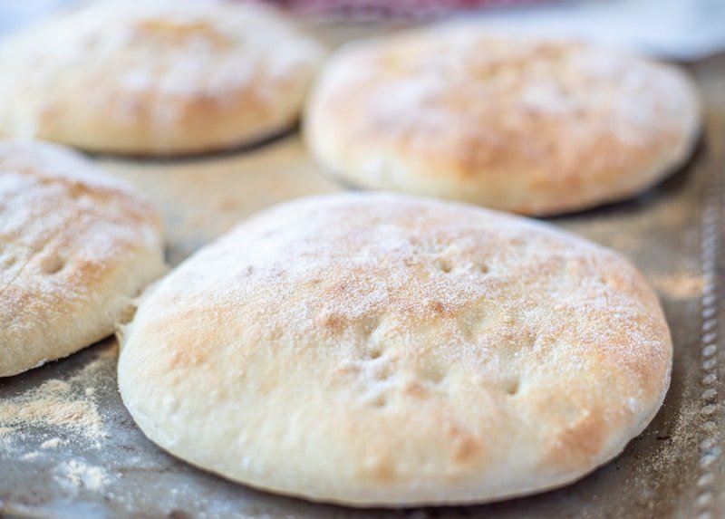 Homemade pita bread on a baking sheet, the best bread made using Somun.