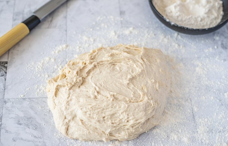 A bowl of flour and dough, ready to make bread or Ćevapi somun.