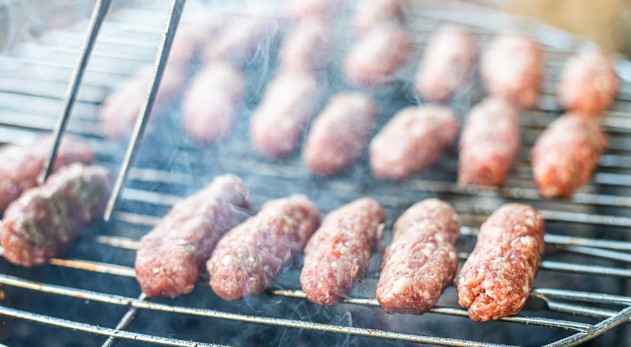 Make skinless sausages are being cooked on a grill.