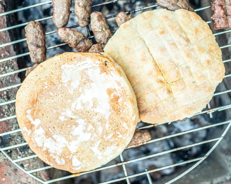 Two Sarajevski Ćevapi and skinless sausages on a grill.