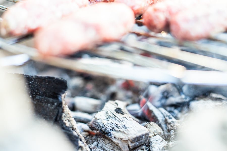 Sarajevski Ćevapi are being cooked on a grill.