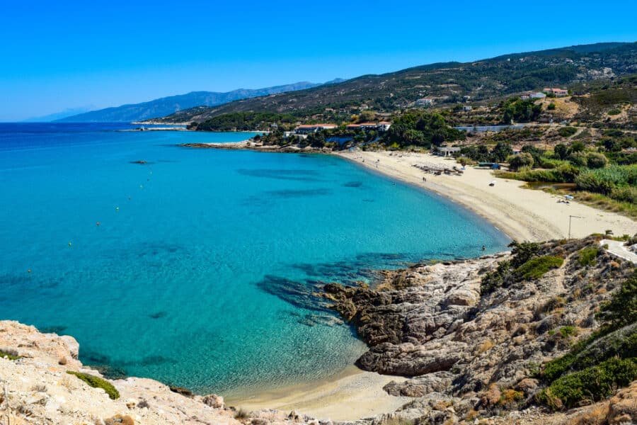 Paradise Greek Aegean Sea beach in Livadi at the Ikaria island in a quiet summer day with flat clear blue water. Near Armenistis
