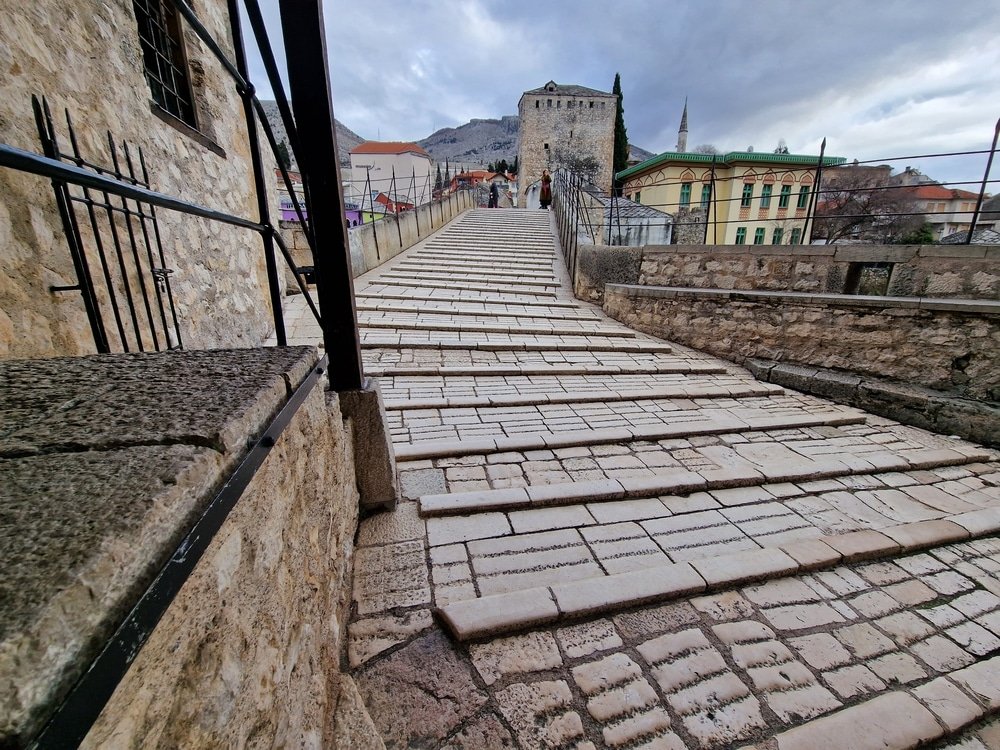 Things to do in Mostar - Experience the enchantment of a stone stairs leading up to a building.