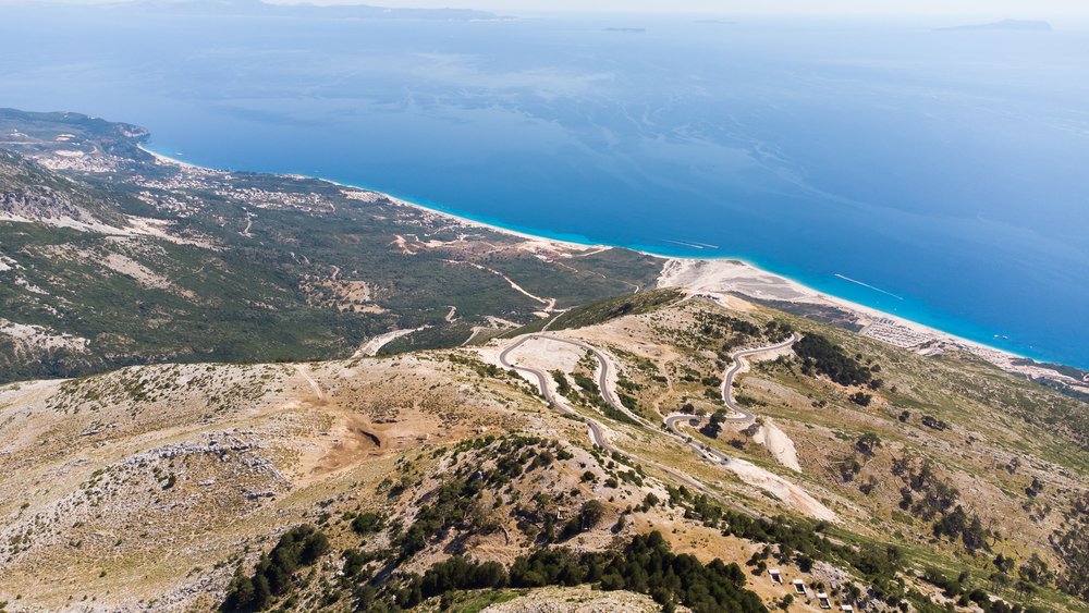 A view of a mountain and ocean from the top of a national park in Albania.