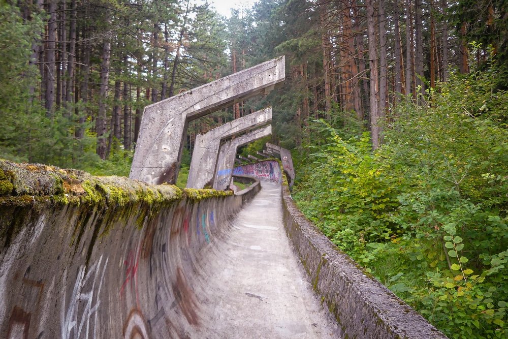 Sarajevo Bobsleigh Track deep within the enchanting woods of Bosnia And Herzegovina, adorned with graffiti. A must-visit for those seeking off-the-beaten-path places