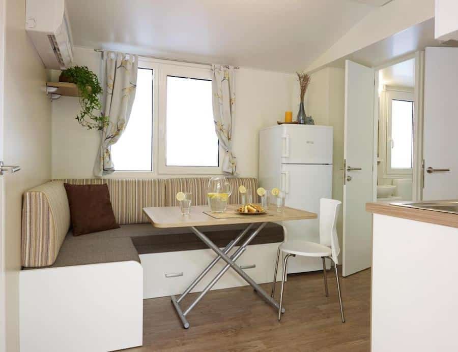 A small kitchen and dining area in a mobile home, perfect for glamping in Slovenia.