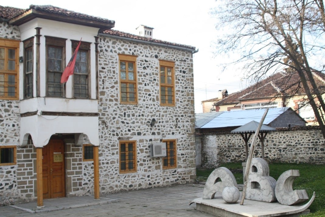 National Museum Of Education. A stone building with a statue in front of it, located in Korçë - the Albanian Little Paris.
