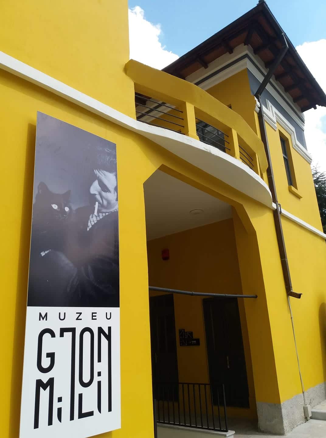 Gjon Mili museum - yellow building with a City Guide sign on it in Korçë, Albania.