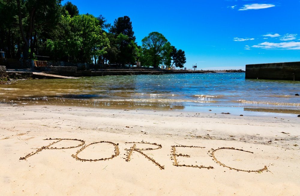 Porec, the name of the town in Croatia, written in sand on the beach in Porec
