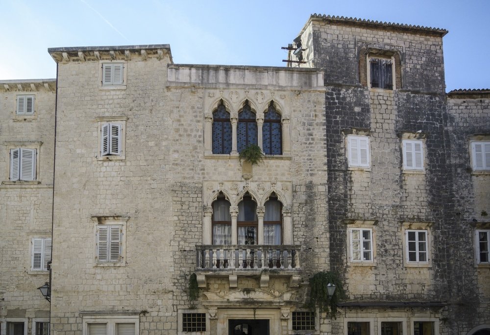 A beautiful stone building adorned with windows and balconies, located in the charming town of Trogir, Croatia. Cipiko palace in the city of Trogir, Croatia
