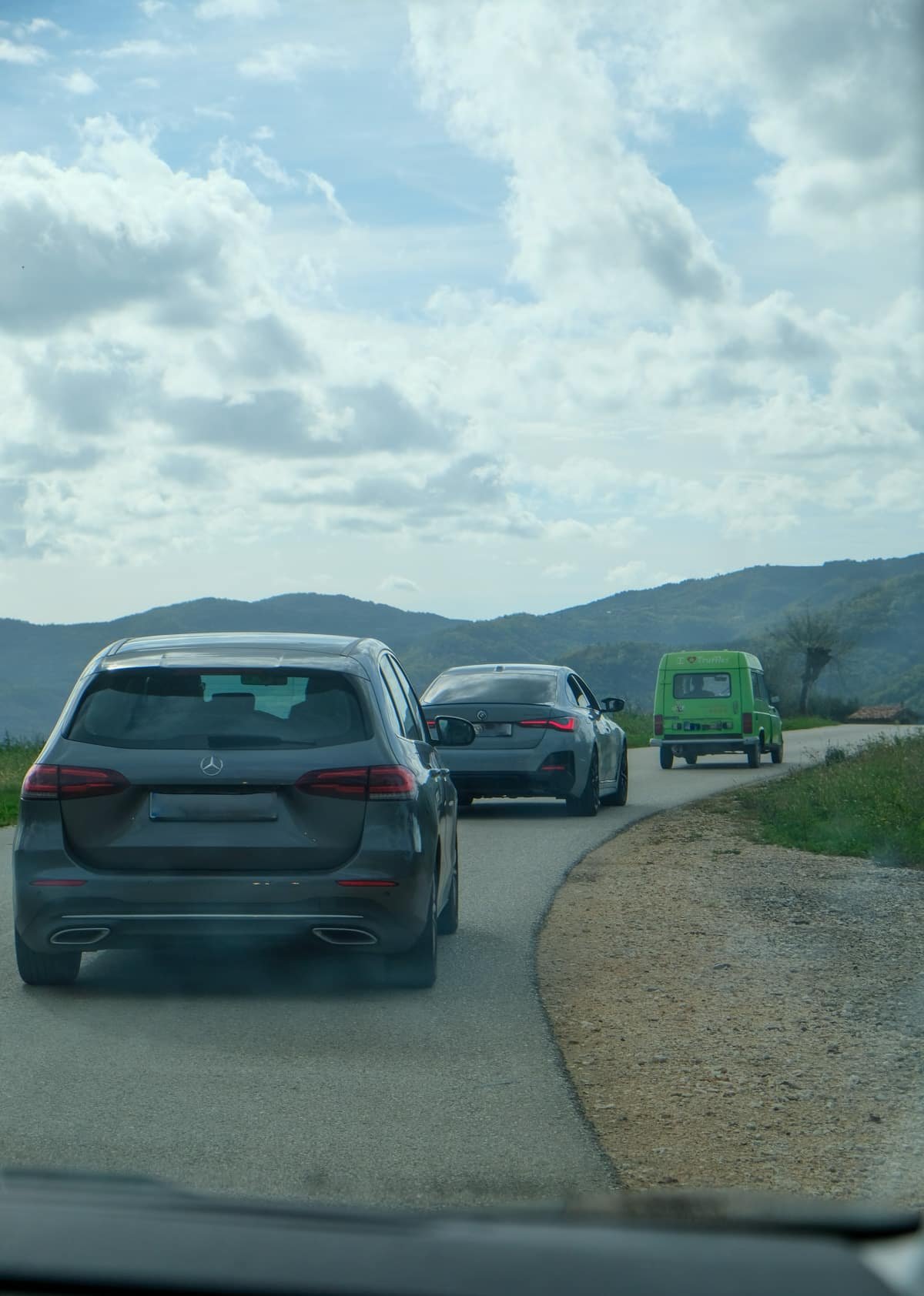 A group of cars driving down a road in Istria. Tips for going to Croatia - drive.