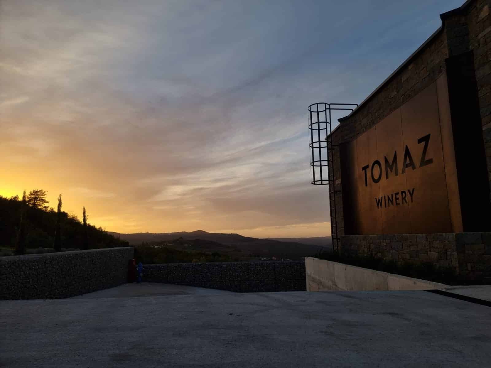 The sign for Tomaz Winery in Istria at sunset.