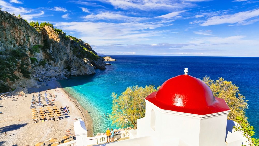 Kyra Panagia Beach with a red dome church on Karpathos Island in Greece.
