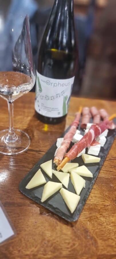 A plate of cheese and wine on a table, perfect for those looking for things to do in Veliko Tarnovo.