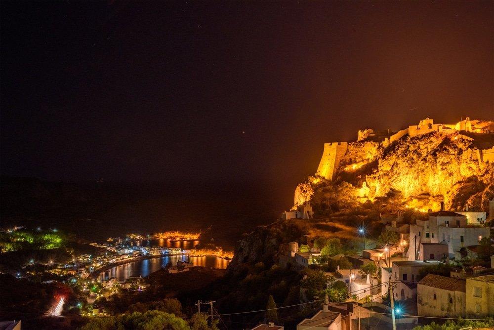 A castle on the island of Kythira is lit up at night in Greece.