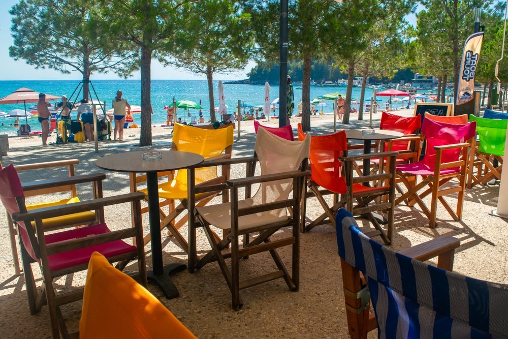 Colorful chairs on the beach in Himare, Albania.