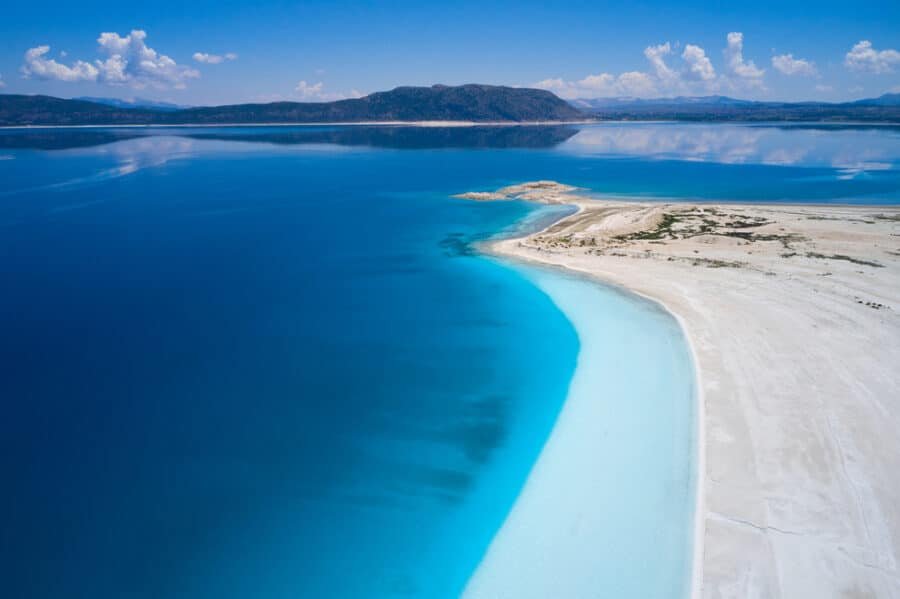 Best Day Trips From Antalya - Blue Salda lake. Aerial view of beautiful white sand beach and unreal blue coastline.