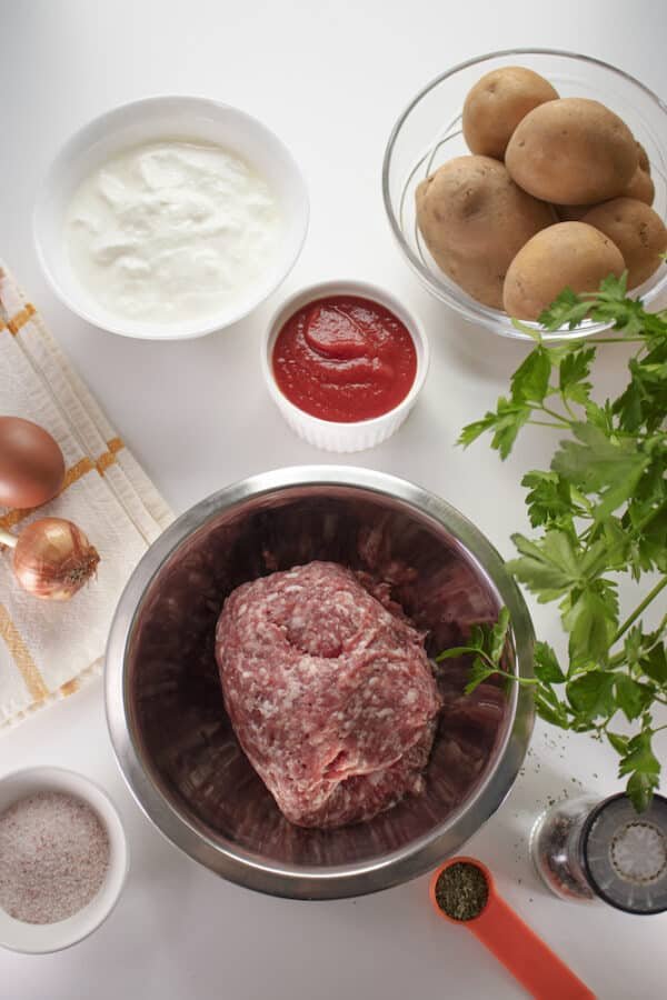 Ingredients for quick and easy meatballs in a bowl on a white background.