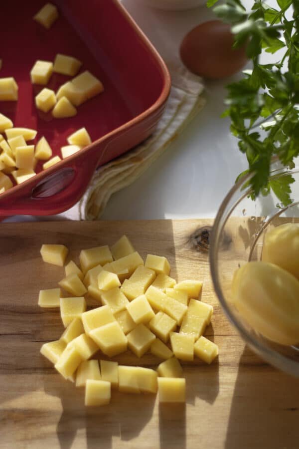 Cubes of cheese on a cutting board for a quick snack.