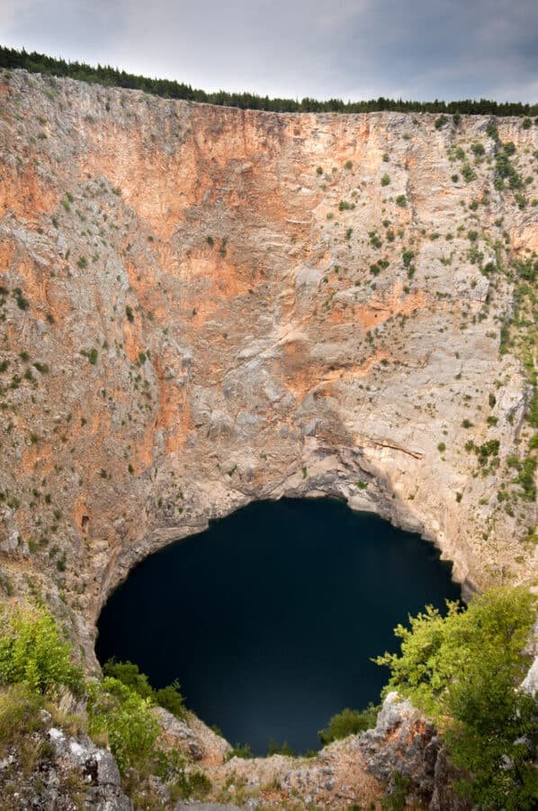 A large hole in the side of a cliff located in Imotski, Croatia.