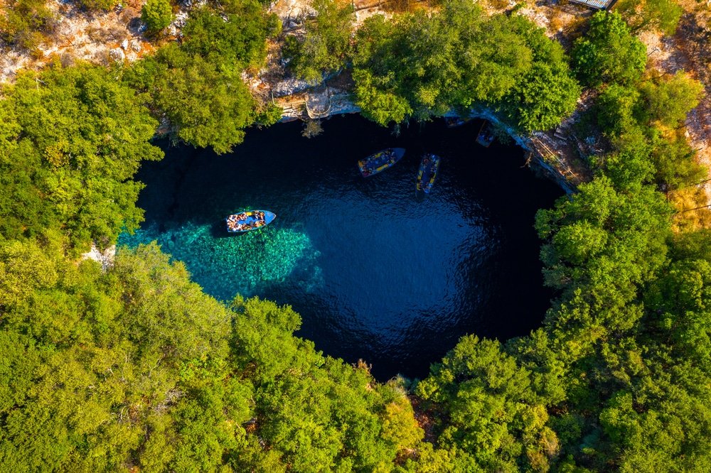 Kefalonia Island Guide - Famous Melissani lake on Kefalonia island, Karavomylos, Greece. On top of Melissani Cave (Melissani Lake) in Karavomylos village in Kefalonia island, Greece. Melissani Cave