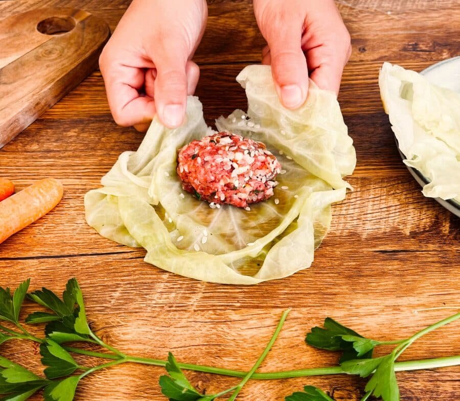 Steps to make sour cabbage meatballs with carrots on a wooden table.