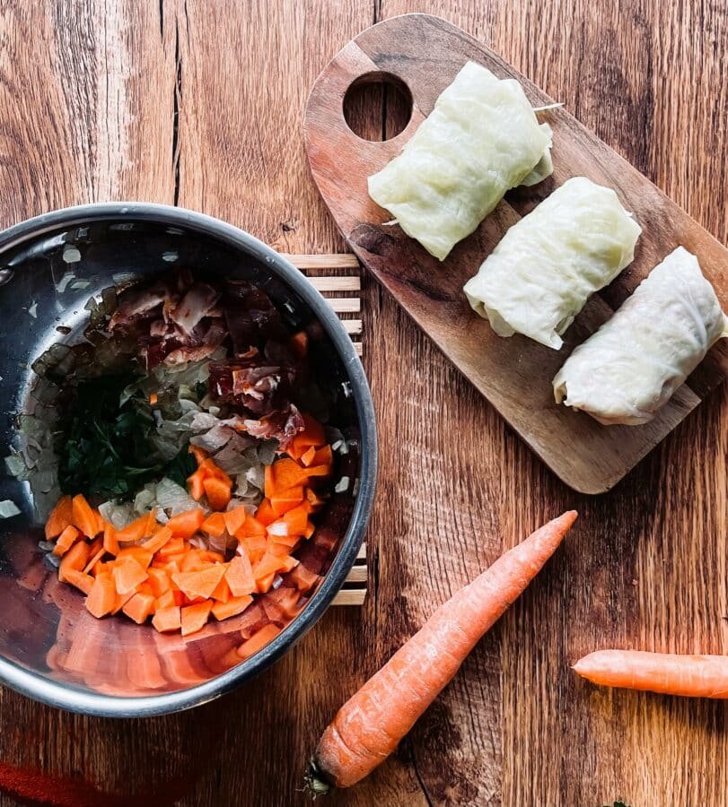 Steps to make sour cabbage rolls with carrots on a wooden table.
