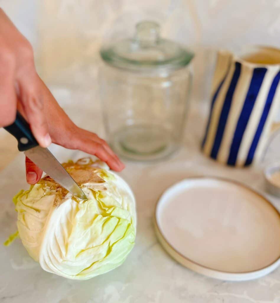 A person making sour cabbage using simple steps.
