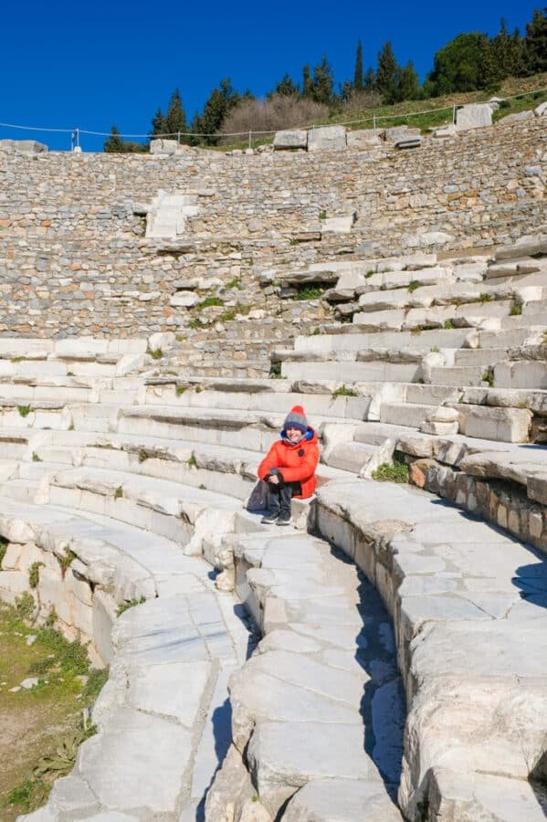 A man sitting on the steps of the ancient theater in Ephesus.