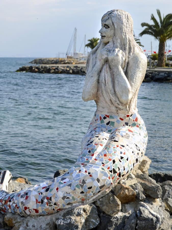 A statue of a mermaid sitting on rocks near the water, located on the Island of Büyükada near Istanbul. Perfect for a day trip to explore the beautiful scenery and enjoy the coastal