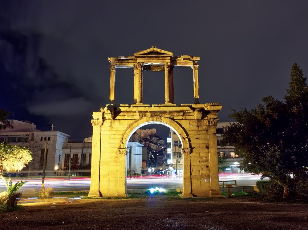 A must-see Night view of Hadrian Arch Temple of Olympian Zeus. in front of a historical building at night, showcasing Athens landmarks. 