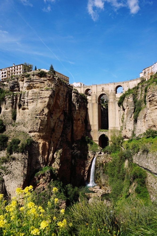 Greece vs Spain - A vertical shot of a Ronda, Spain with an old beautiful bridge