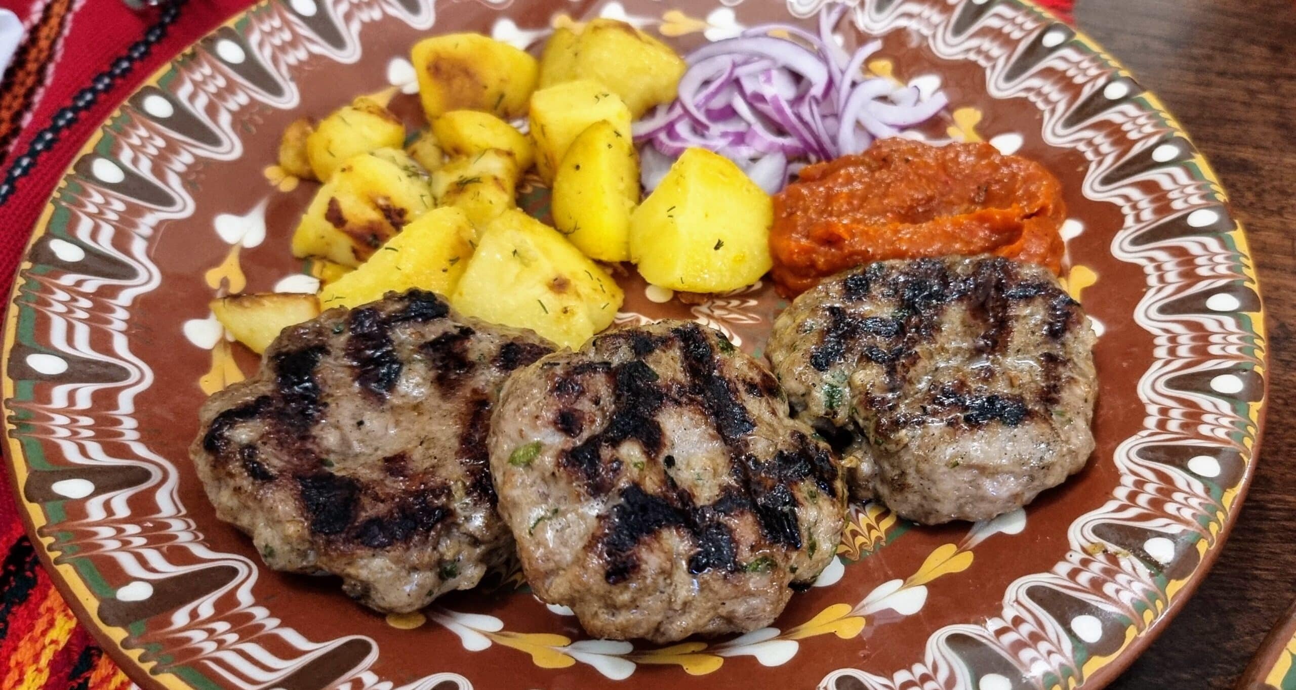 A plate of Bulgarian Kofte, potatoes and onions - a favorite dish in Bulgaria.