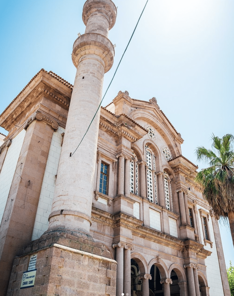 Çınarlı Cami Mosque with a clock tower and palm trees in Ayvalik, Turkey.