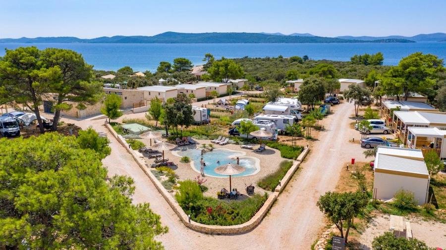 An aerial view of a glamping site at an rv park near the sea in Croatia.