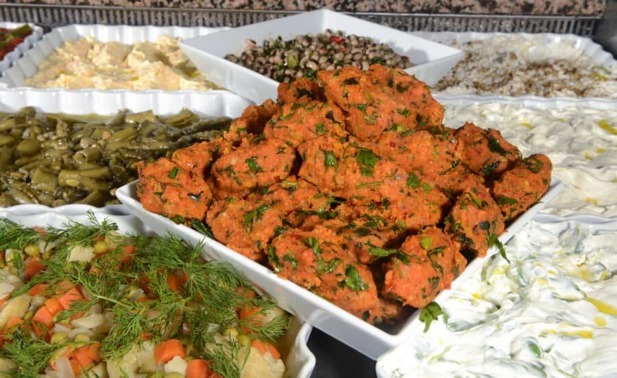 A tray full of Mercimekli kofte, bursting with vibrant spices.