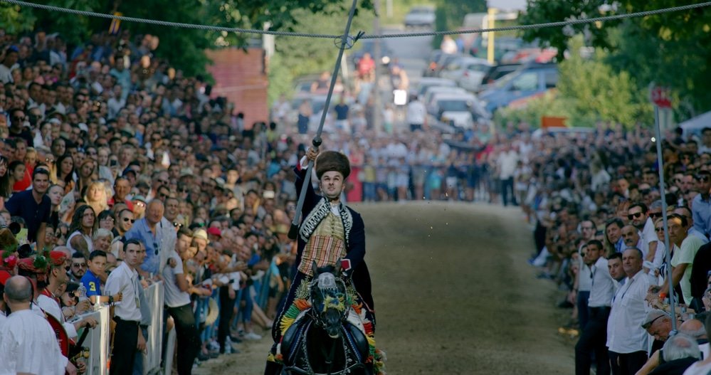 A man riding a horse in front of a cheering crowd during the Sinj event in Croatia.