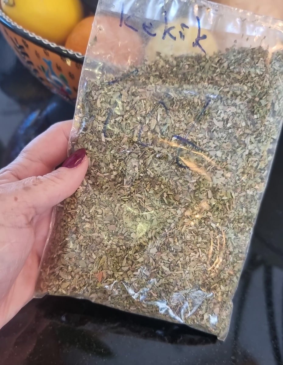 SJ holding a bag of Turkish dried herbs - oregano