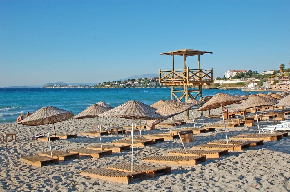 A beach in Turkey adorned with wooden lounge chairs and umbrellas, perfect for celebrating the New Year.