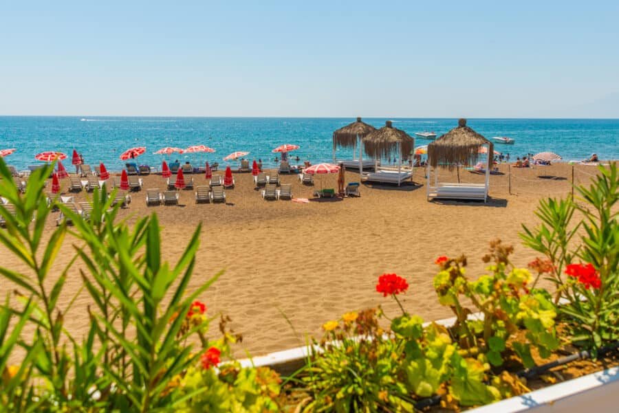 Gazebos, sun loungers and umbrellas on the Lara beach on a sunny summer day in Antalya, Turkey.