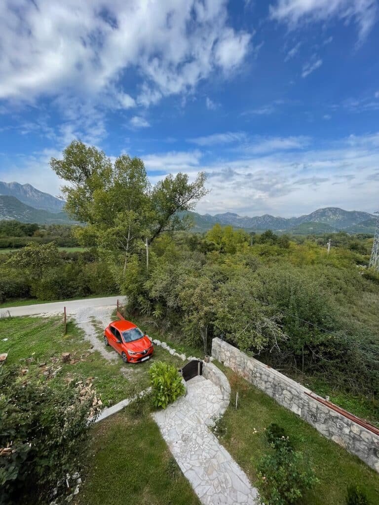 Renting A Car In Montenegro - Red Car in driveway