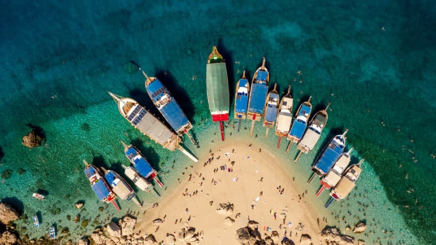 A collection of boats parked on one of the best beaches in Antalya - Suluada Beach